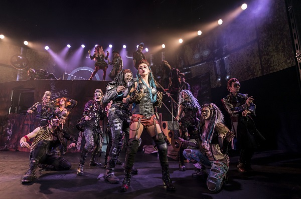 We Will Rock You Bristol. A production shot of the musical featuring multiple cast members dressed in alternative rock, goth, industrial and metal attire