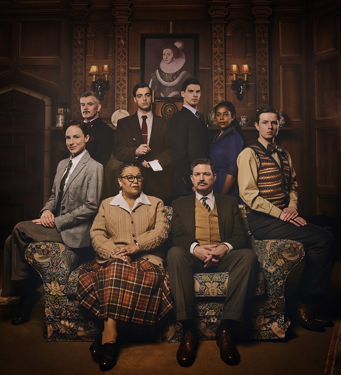 The Mousetrap 2021 London cast. Image features a group of actors grouped together in period dress, in a stately home all looking a bit shifty - The Mousetrap Bristol Hippodrome Date Booking Now