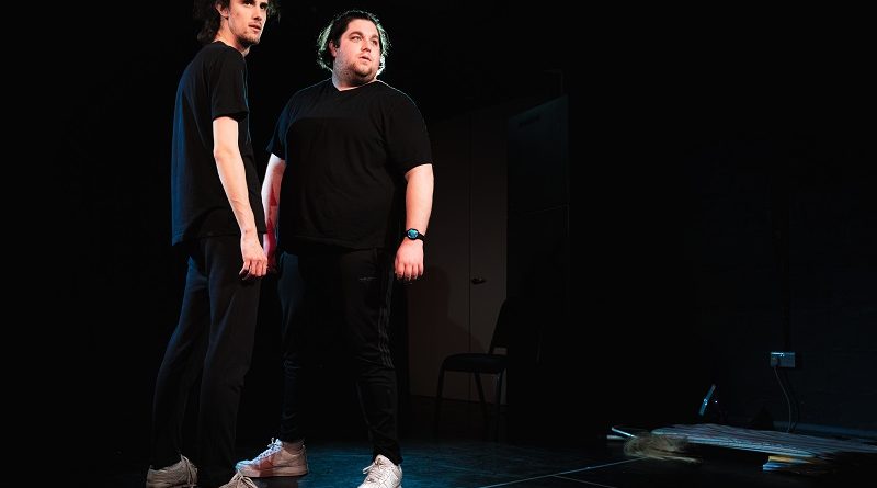 Jack and Jordan A Sketch Show Two men dressed in black stand on a stage looking into the distance