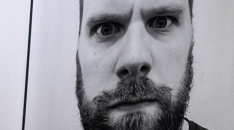 Christmas Carol Goes Wrong Review - A large black and white photograph of an imposing man